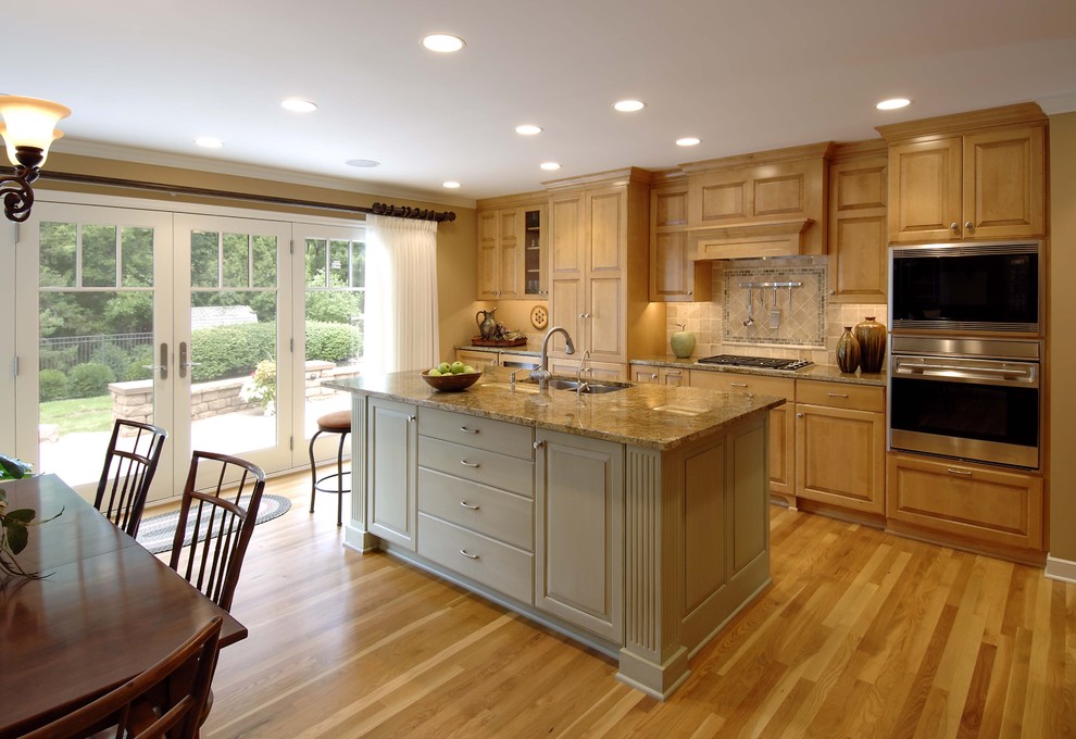 Kitchen - traditional kitchen idea in Minneapolis with raised-panel cabinets and stainless steel appliances