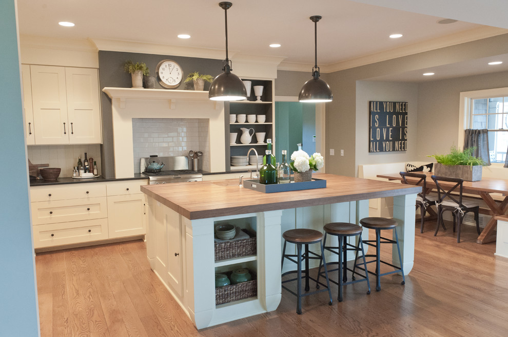 Eat-in kitchen - coastal eat-in kitchen idea in Minneapolis with shaker cabinets, white cabinets, wood countertops, white backsplash and subway tile backsplash