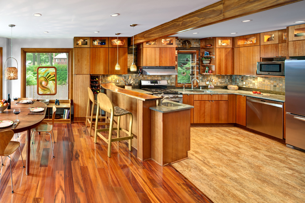 Mid-sized u-shaped medium tone wood floor and beige floor open concept kitchen photo in Cleveland with an undermount sink, flat-panel cabinets, medium tone wood cabinets, wood countertops, multicolored backsplash, stone tile backsplash, stainless steel appliances and a peninsula