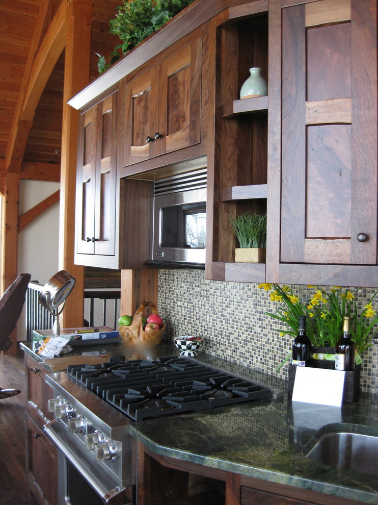 Einzeilige Rustikale Wohnküche mit Doppelwaschbecken, hellbraunen Holzschränken, Granit-Arbeitsplatte, Rückwand aus Glasfliesen, Küchengeräten aus Edelstahl und braunem Holzboden in New York