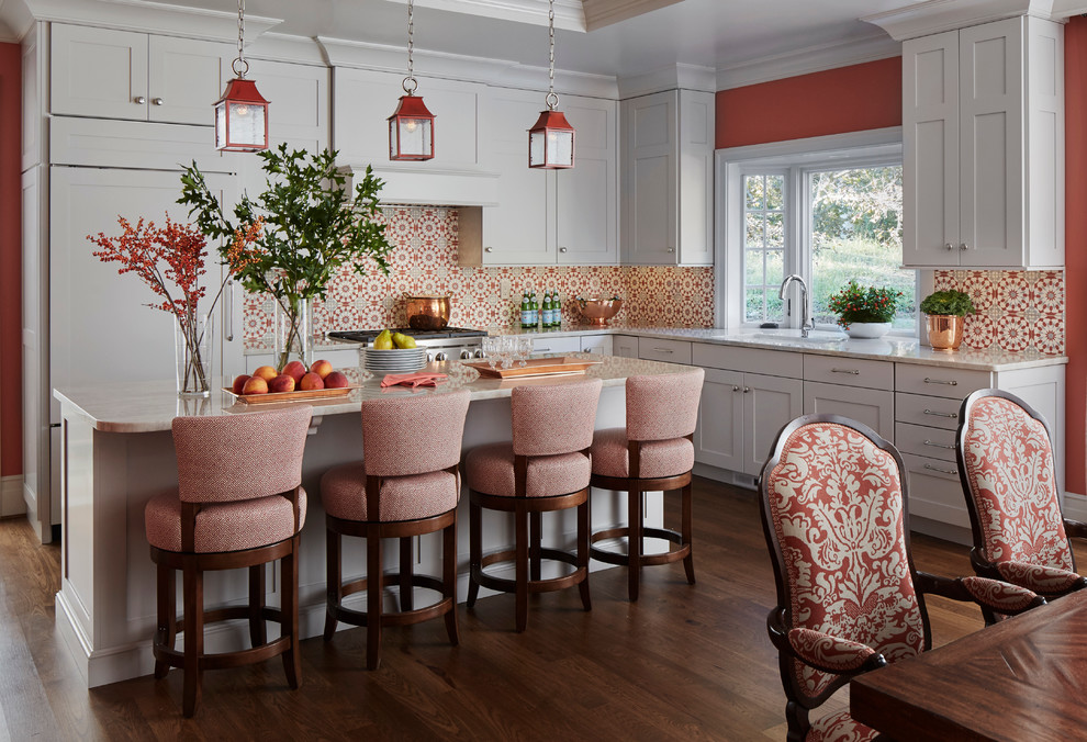 Eat-in kitchen - large traditional l-shaped dark wood floor eat-in kitchen idea in Chicago with gray cabinets, quartzite countertops, cement tile backsplash, paneled appliances, an island, shaker cabinets and multicolored backsplash