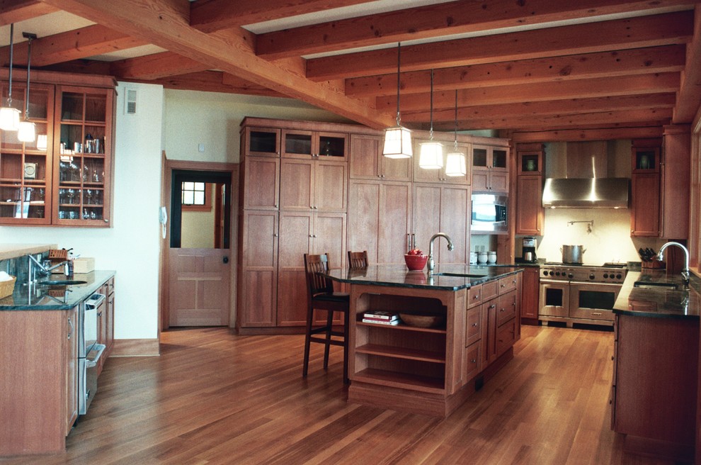 Inspiration for a large rustic u-shaped medium tone wood floor eat-in kitchen remodel in New York with shaker cabinets, medium tone wood cabinets, stainless steel appliances and an island