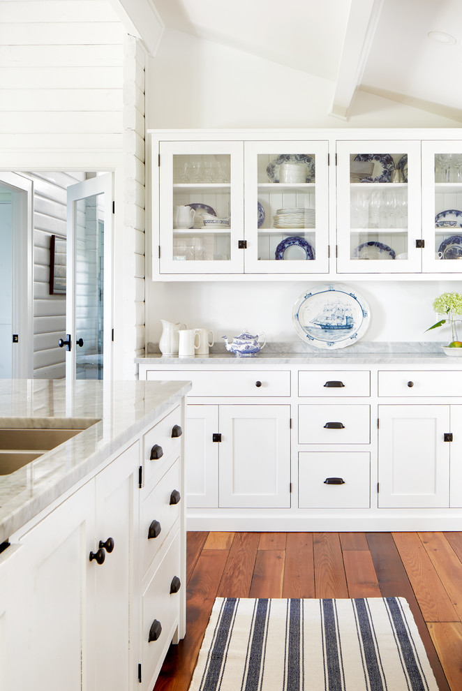 Mid-sized beach style l-shaped medium tone wood floor and brown floor open concept kitchen photo in Toronto with an undermount sink, shaker cabinets, white cabinets, marble countertops, gray backsplash, stone tile backsplash, stainless steel appliances, an island and gray countertops