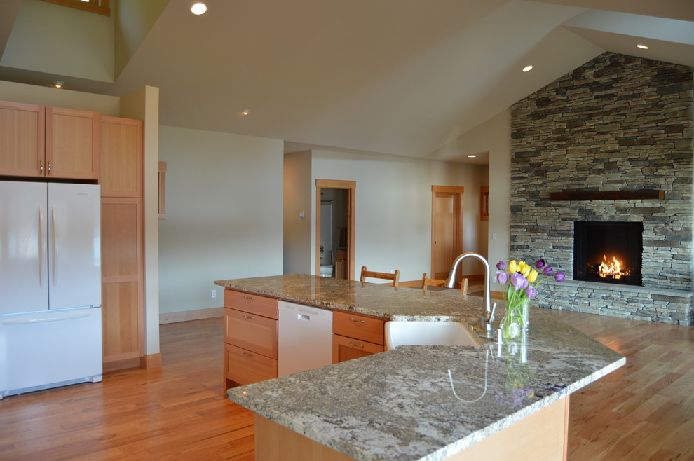 Example of a mid-sized arts and crafts light wood floor enclosed kitchen design in Seattle with an undermount sink, recessed-panel cabinets, light wood cabinets, granite countertops, gray backsplash, mosaic tile backsplash, white appliances and an island
