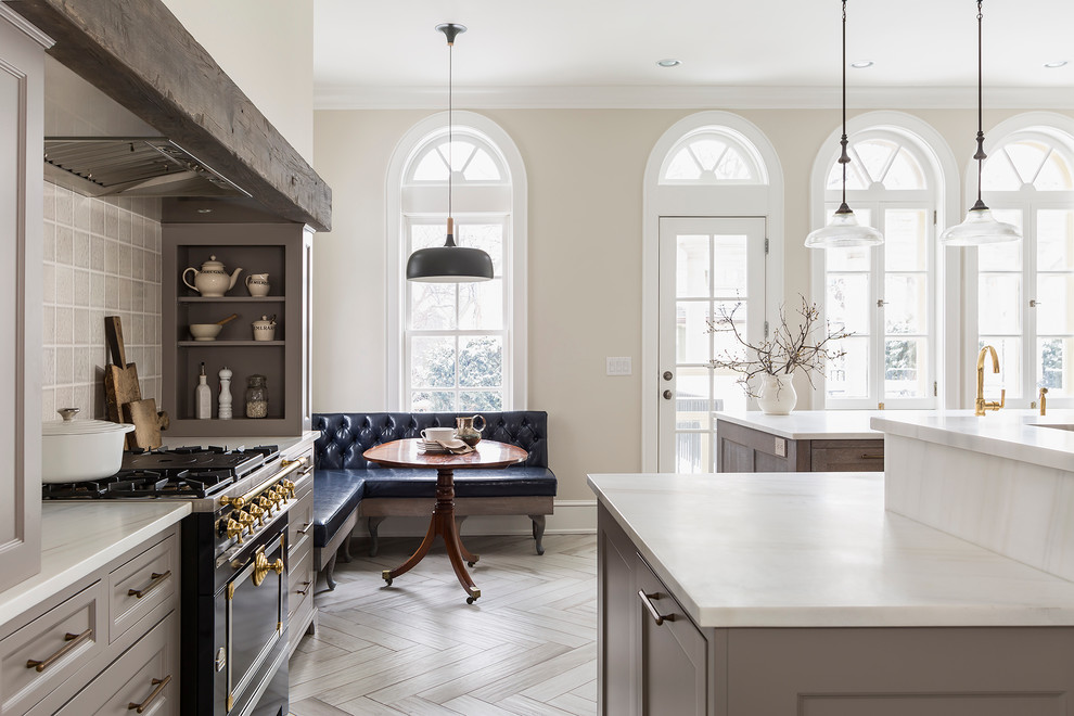 Large transitional porcelain tile kitchen photo in Minneapolis with marble countertops, paneled appliances and an island