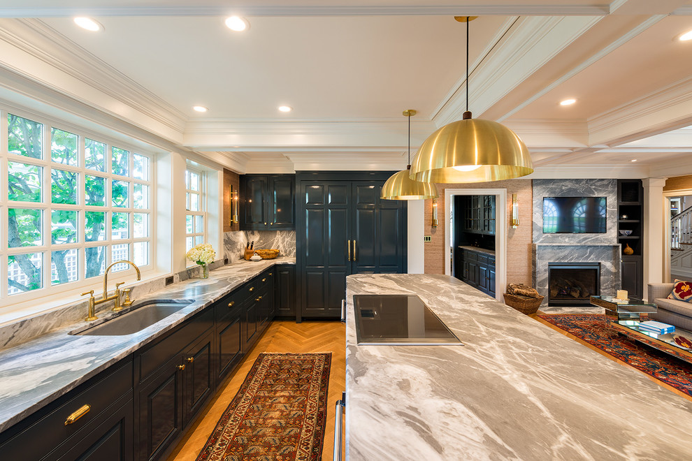Inspiration for a large timeless u-shaped light wood floor eat-in kitchen remodel in Minneapolis with an undermount sink, raised-panel cabinets, marble countertops, stone tile backsplash, an island, blue cabinets, white backsplash and paneled appliances