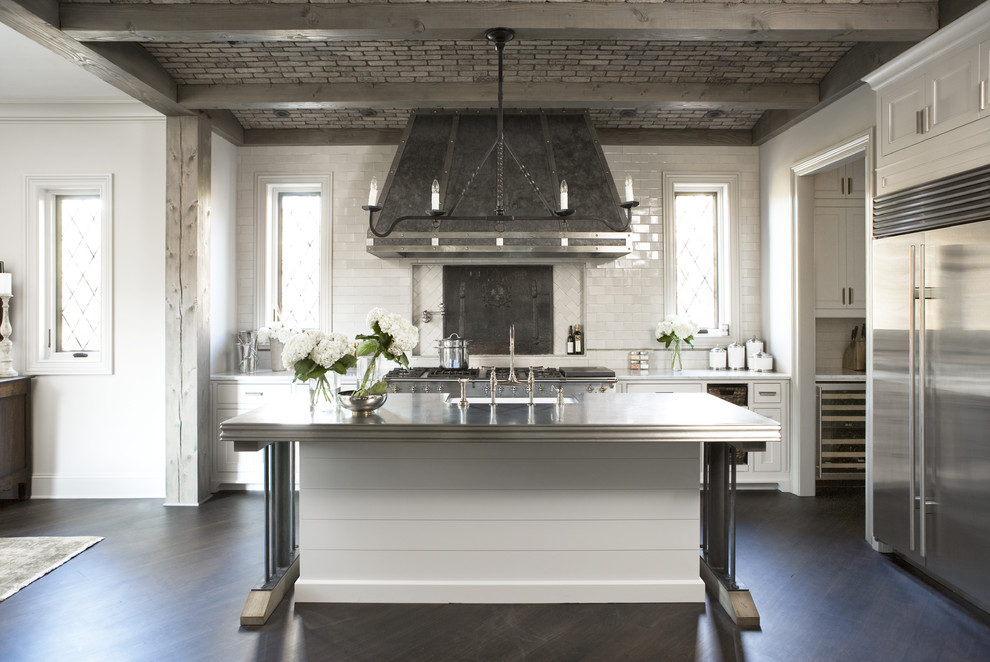 Example of a large transitional galley dark wood floor open concept kitchen design in Other with subway tile backsplash, stainless steel appliances, white cabinets, granite countertops, white backsplash, an island and shaker cabinets