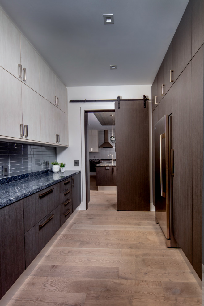 Example of a large trendy galley brown floor kitchen pantry design in Toronto with flat-panel cabinets, medium tone wood cabinets, gray backsplash, ceramic backsplash, no island and gray countertops
