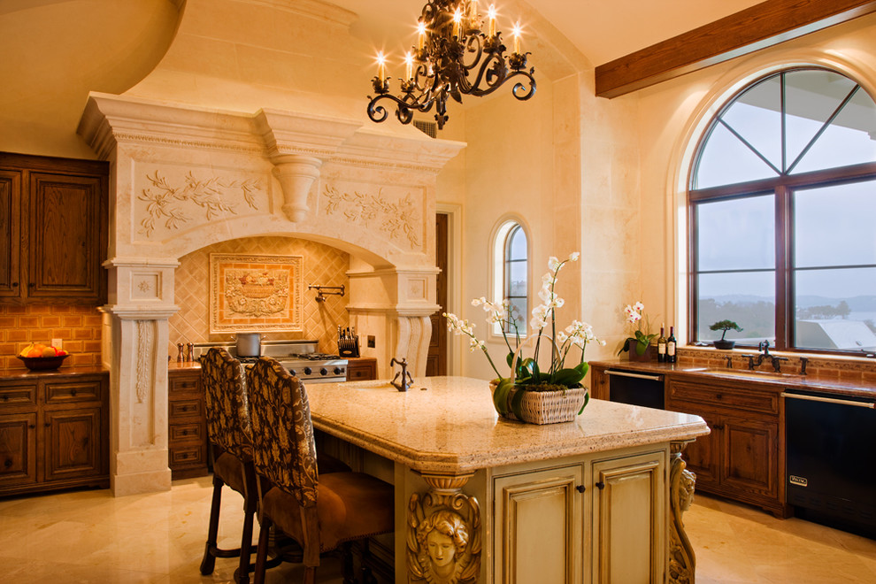 Inspiration for a mid-sized mediterranean ceramic tile enclosed kitchen remodel in Austin with an undermount sink, raised-panel cabinets, medium tone wood cabinets, terrazzo countertops, beige backsplash, ceramic backsplash, stainless steel appliances and an island