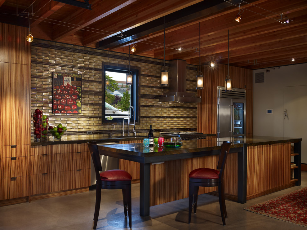 Inspiration for a small modern single-wall concrete floor and beige floor eat-in kitchen remodel in Seattle with an undermount sink, flat-panel cabinets, medium tone wood cabinets, granite countertops, green backsplash, glass tile backsplash, stainless steel appliances and an island