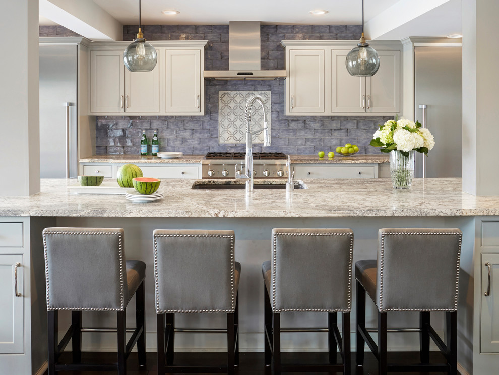 Example of a mid-sized transitional galley dark wood floor and brown floor kitchen design in Chicago with an undermount sink, beaded inset cabinets, gray cabinets, quartzite countertops, blue backsplash, stainless steel appliances, an island and gray countertops