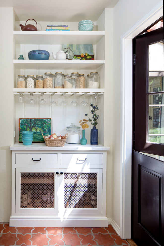 Inspiration for a large mediterranean single-wall terra-cotta tile and orange floor kitchen pantry remodel in Los Angeles with white cabinets, marble countertops, white backsplash, wood backsplash and shaker cabinets