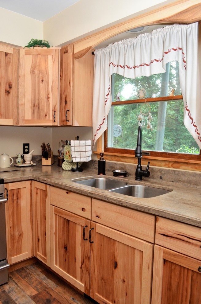 Eat-in kitchen - mid-sized rustic l-shaped medium tone wood floor and brown floor eat-in kitchen idea in Other with an undermount sink, shaker cabinets, medium tone wood cabinets, solid surface countertops, a peninsula, beige countertops and stainless steel appliances