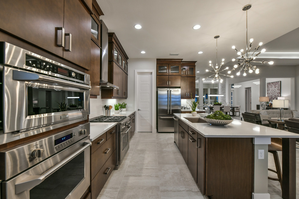 Open concept kitchen - large modern l-shaped open concept kitchen idea in Other with a single-bowl sink, flat-panel cabinets, medium tone wood cabinets, white backsplash, subway tile backsplash, stainless steel appliances and an island