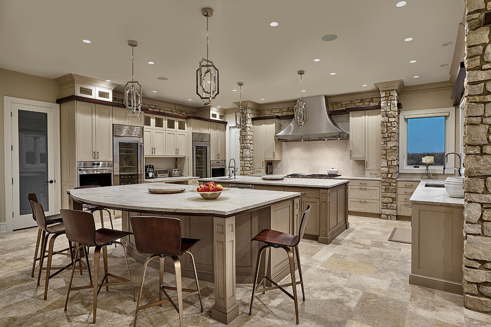 Mid-sized transitional u-shaped limestone floor eat-in kitchen photo in Chicago with an undermount sink, recessed-panel cabinets, beige cabinets, quartzite countertops, white backsplash, stone tile backsplash, stainless steel appliances and two islands