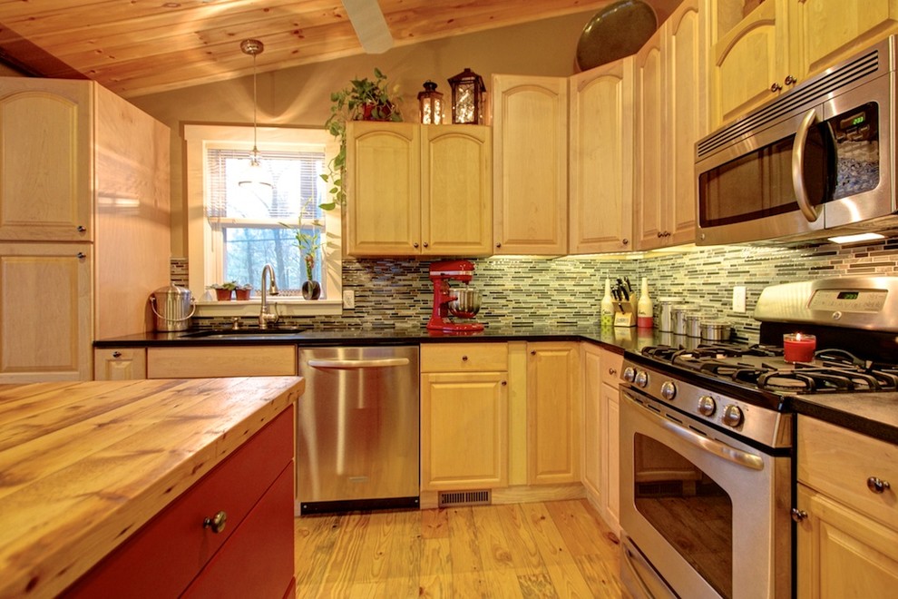 Small mountain style l-shaped light wood floor open concept kitchen photo in Boston with an undermount sink, raised-panel cabinets, light wood cabinets, granite countertops, multicolored backsplash, glass sheet backsplash, stainless steel appliances and an island