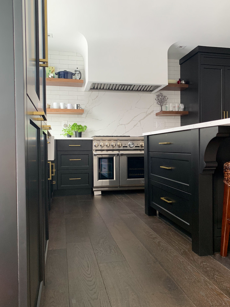 Inspiration for a traditional kitchen in Grand Rapids with black cabinets, white splashback and white worktops.
