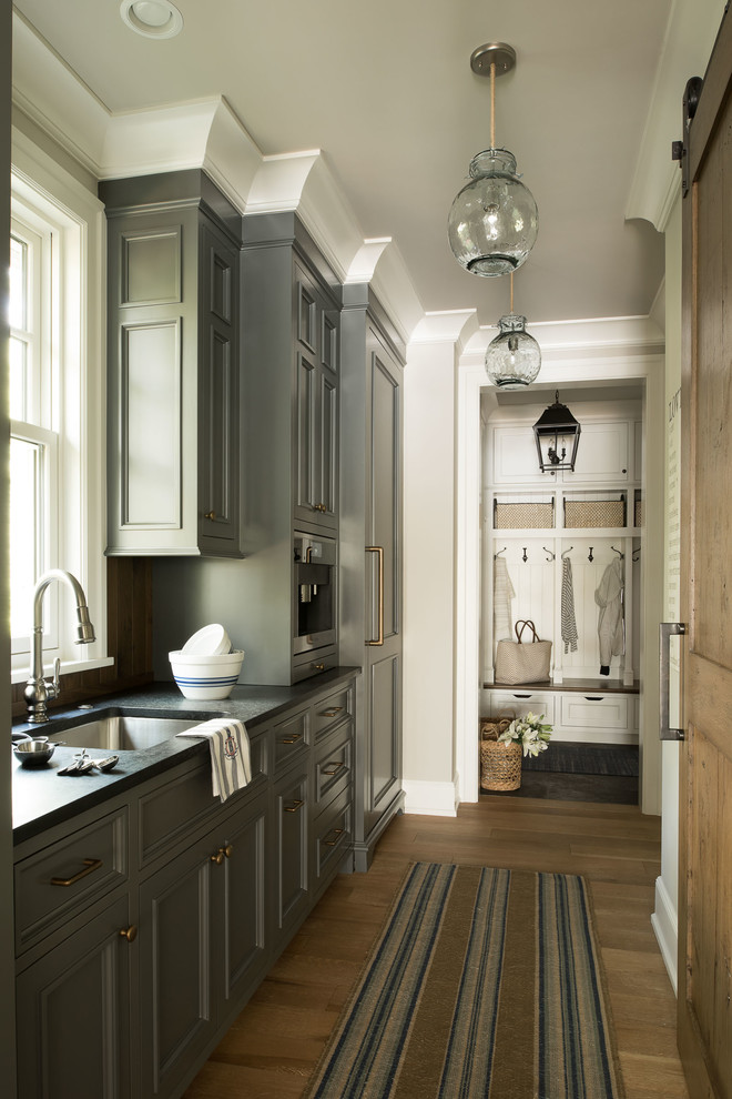 Inspiration for a nautical grey and cream single-wall kitchen in Minneapolis with a submerged sink, recessed-panel cabinets, grey cabinets, integrated appliances, medium hardwood flooring and brown floors.