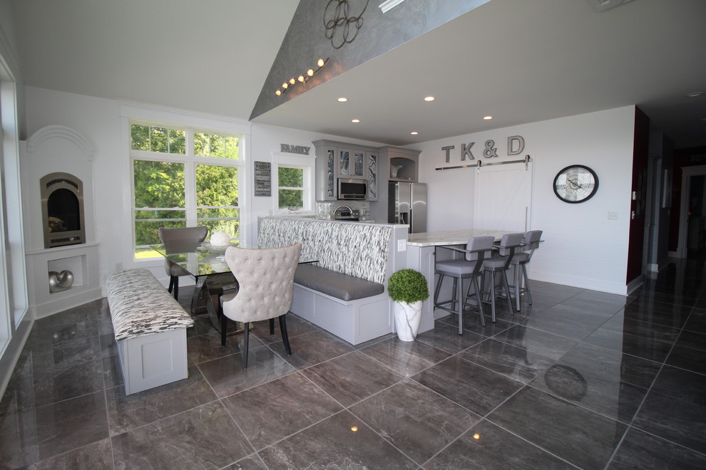 Eat-in kitchen - mid-sized modern u-shaped porcelain tile and gray floor eat-in kitchen idea in Burlington with an undermount sink, shaker cabinets, gray cabinets, marble countertops, white backsplash, marble backsplash and stainless steel appliances