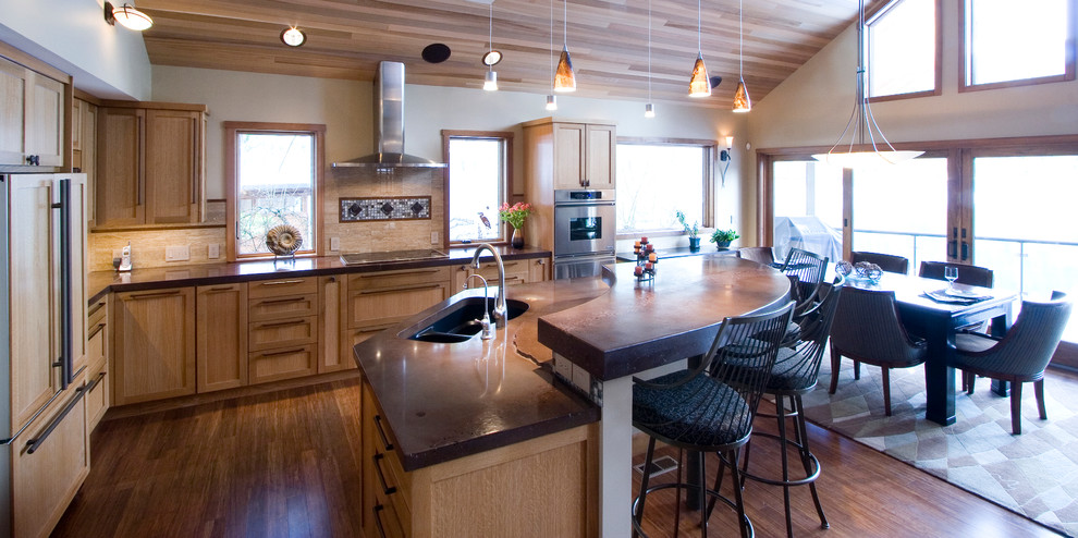 Trendy l-shaped eat-in kitchen photo in Seattle with an undermount sink, shaker cabinets, medium tone wood cabinets, beige backsplash and paneled appliances