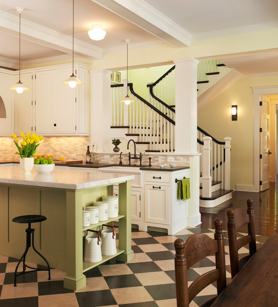 Example of a beach style linoleum floor kitchen design in DC Metro with beige backsplash, white cabinets, recessed-panel cabinets and a farmhouse sink
