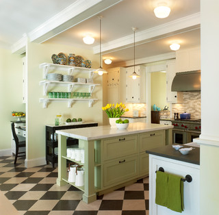 Sage green kitchen with shaker cabinets in a renovated 1880s house