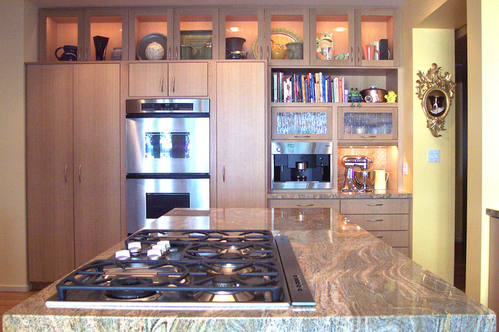 This is an example of a medium sized classic u-shaped kitchen/diner in Seattle with a single-bowl sink, flat-panel cabinets, light wood cabinets, granite worktops, stainless steel appliances, light hardwood flooring and multiple islands.
