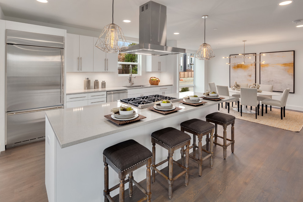 Inspiration for a contemporary galley kitchen in Seattle with a single-bowl sink, white cabinets, quartz worktops, white splashback, stainless steel appliances, an island and beige worktops.
