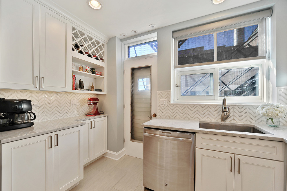 Large classic galley enclosed kitchen in Chicago with a submerged sink, shaker cabinets, white cabinets, quartz worktops, white splashback, mosaic tiled splashback, stainless steel appliances, porcelain flooring and no island.