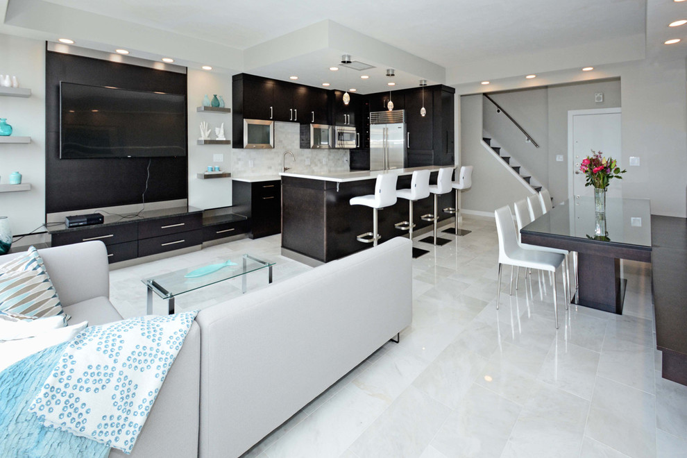 This is an example of a medium sized modern u-shaped open plan kitchen in Cleveland with a submerged sink, flat-panel cabinets, black cabinets, quartz worktops, white splashback, marble splashback, stainless steel appliances, marble flooring, a breakfast bar and white floors.