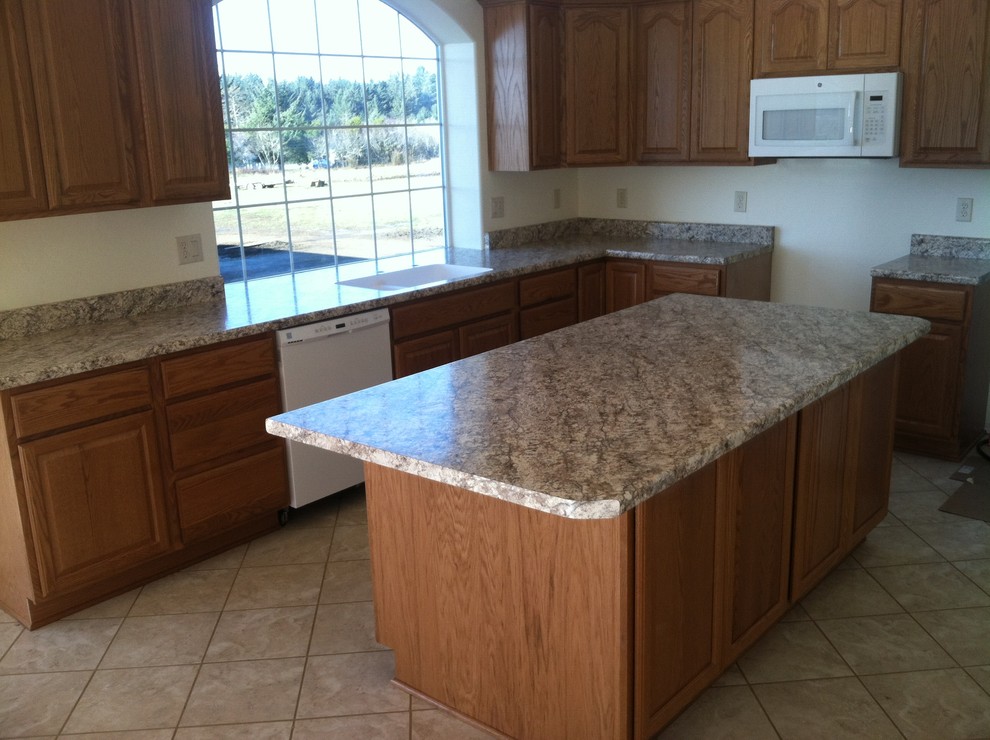 Example of a trendy ceramic tile kitchen design in Other with an undermount sink, raised-panel cabinets, medium tone wood cabinets, laminate countertops, white appliances and an island
