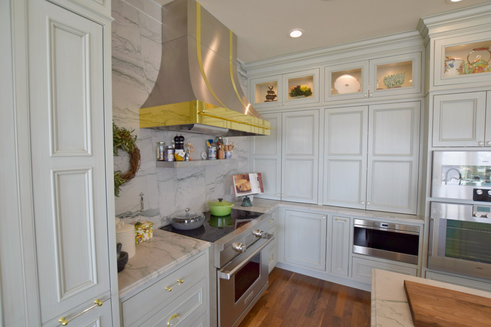 Large classic l-shaped open plan kitchen in Denver with a submerged sink, beaded cabinets, grey cabinets, white splashback, marble splashback, stainless steel appliances, medium hardwood flooring and an island.