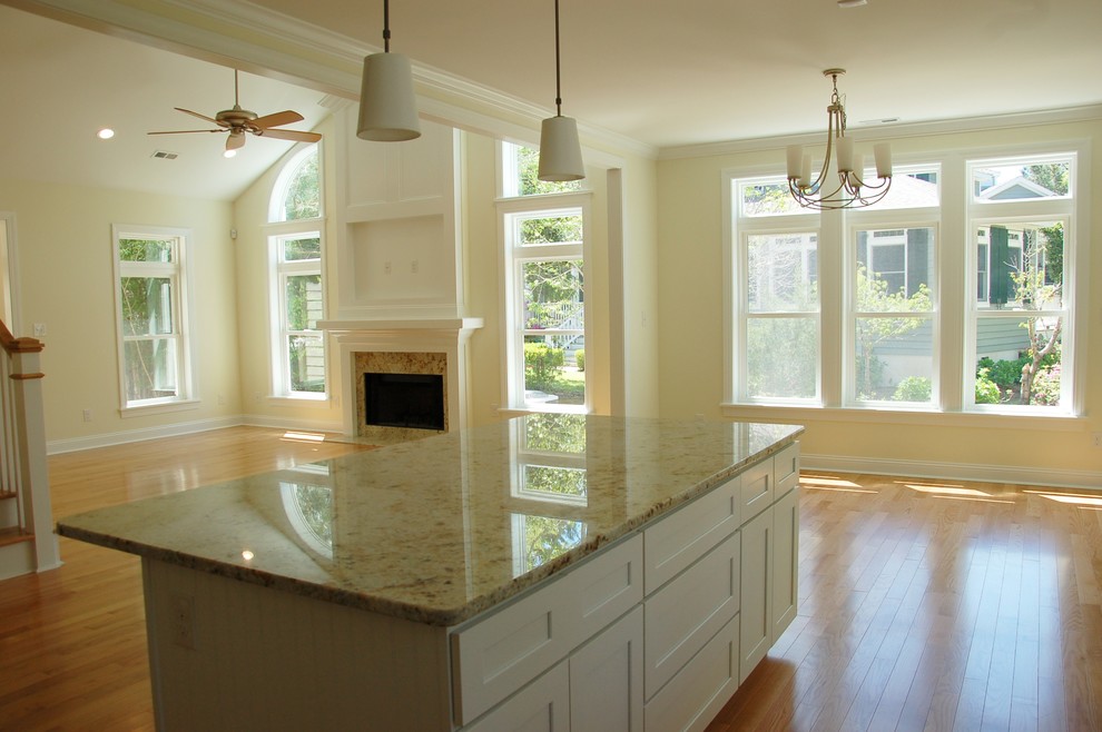 Exempel på ett mellanstort maritimt beige beige kök, med skåp i shakerstil, vita skåp, granitbänkskiva, ljust trägolv, en köksö och beiget golv