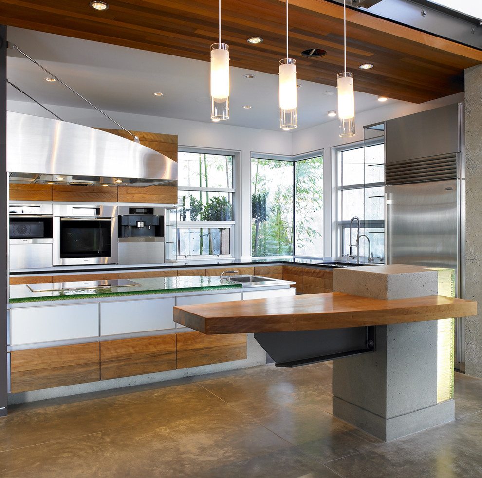 Example of a trendy kitchen design in Vancouver with glass countertops