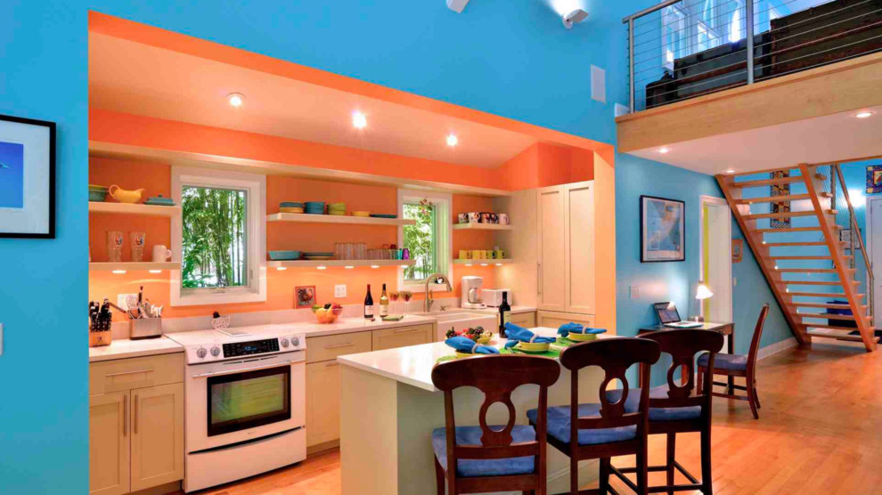 Inspiration for a small tropical galley medium tone wood floor open concept kitchen remodel in Miami with a farmhouse sink, shaker cabinets, green cabinets and an island