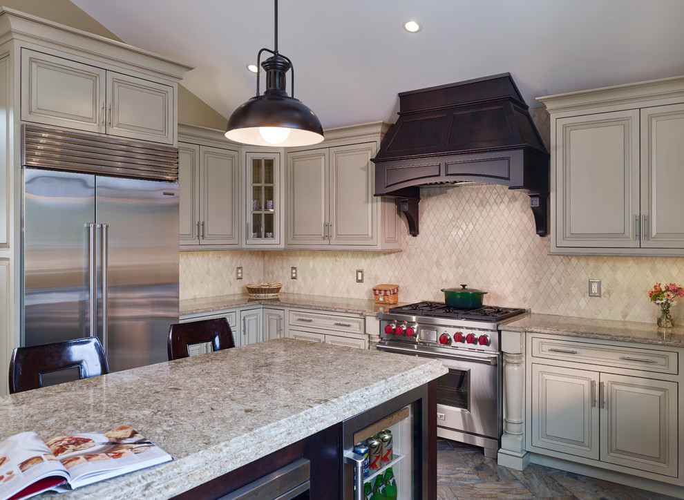 Eat-in kitchen - huge traditional u-shaped ceramic tile and multicolored floor eat-in kitchen idea in Philadelphia with a farmhouse sink, raised-panel cabinets, white cabinets, granite countertops, beige backsplash, terra-cotta backsplash, stainless steel appliances and an island