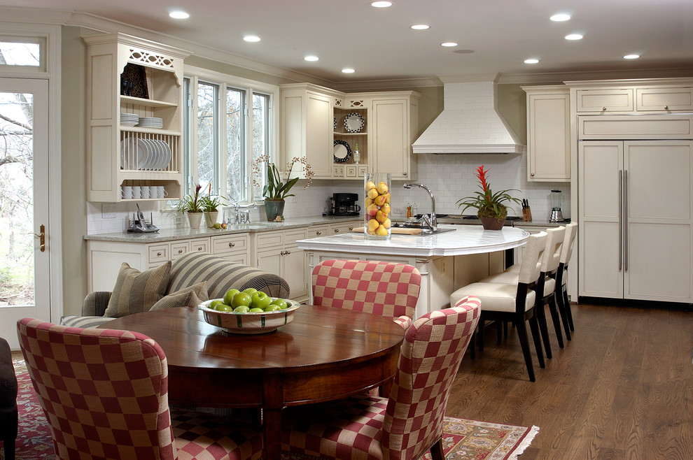 Mid-sized arts and crafts l-shaped medium tone wood floor eat-in kitchen photo in DC Metro with a double-bowl sink, louvered cabinets, white cabinets, granite countertops, white backsplash, subway tile backsplash, stainless steel appliances and an island