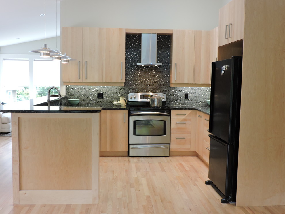 Inspiration for a mid-sized contemporary u-shaped light wood floor open concept kitchen remodel in Vancouver with an undermount sink, flat-panel cabinets, light wood cabinets, quartz countertops, black backsplash, mosaic tile backsplash and black appliances
