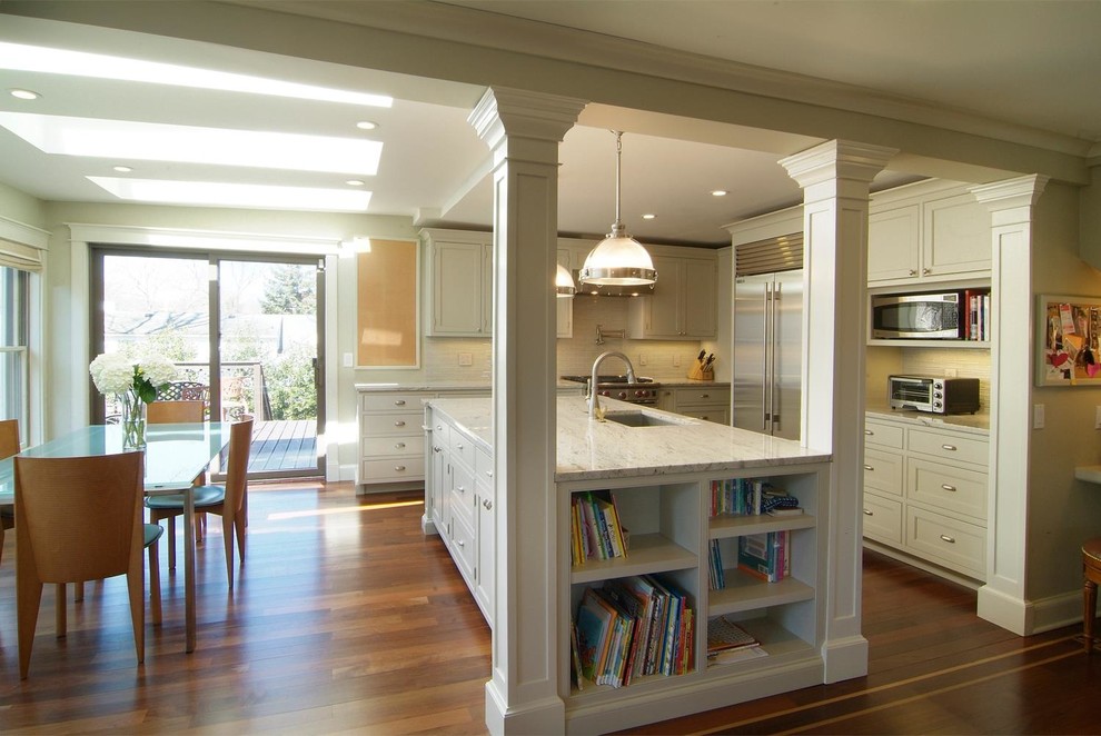 Eat-in kitchen - mid-sized traditional l-shaped dark wood floor and brown floor eat-in kitchen idea in Other with a single-bowl sink, shaker cabinets, white cabinets, granite countertops, white backsplash, subway tile backsplash, stainless steel appliances and an island