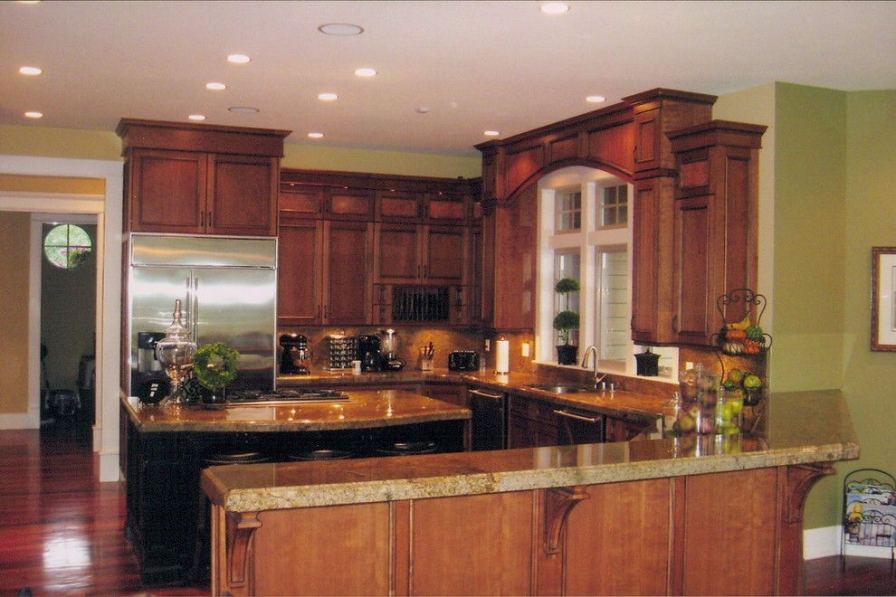 Example of a mid-sized classic galley medium tone wood floor eat-in kitchen design in Seattle with an undermount sink, shaker cabinets, medium tone wood cabinets, granite countertops, multicolored backsplash, ceramic backsplash, stainless steel appliances and an island