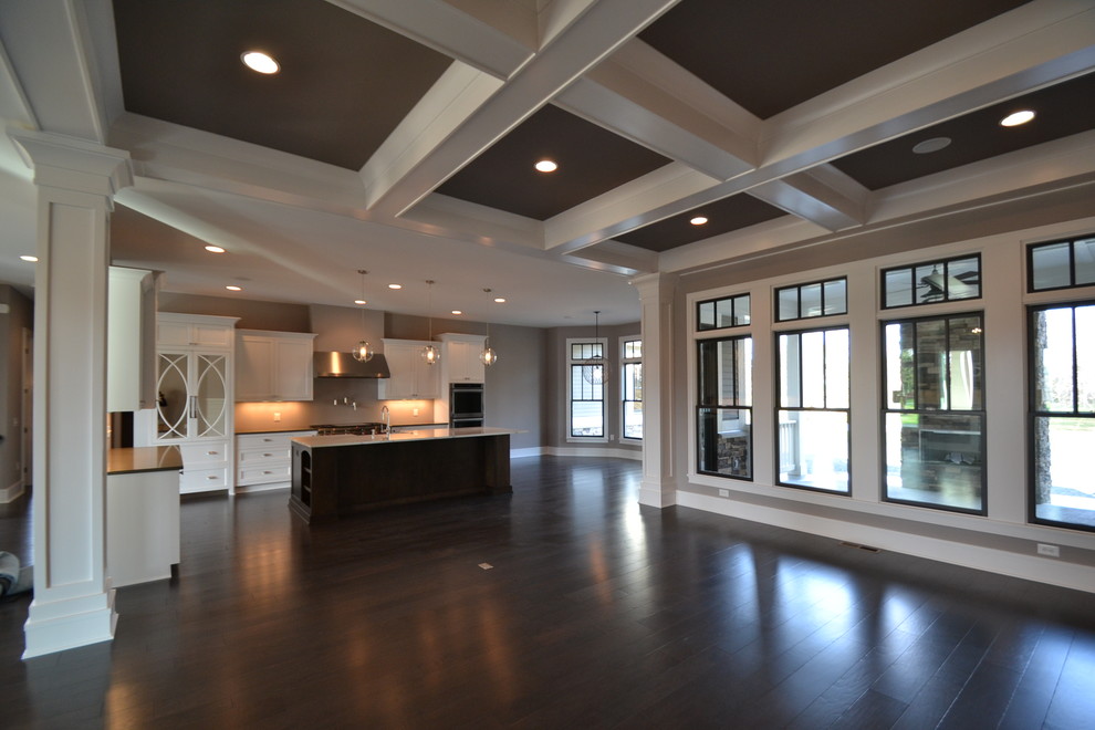 Example of a large trendy l-shaped dark wood floor eat-in kitchen design in Indianapolis with a farmhouse sink, beaded inset cabinets, white cabinets, marble countertops, stainless steel appliances and an island