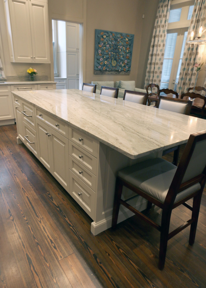 Inspiration for a large timeless u-shaped medium tone wood floor and brown floor enclosed kitchen remodel in New Orleans with raised-panel cabinets, white cabinets, marble countertops, gray backsplash, marble backsplash, an island and white countertops