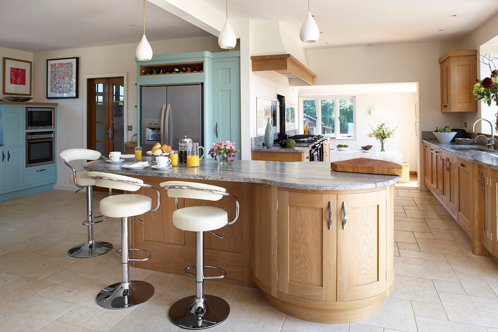 Photo of an expansive rural grey and cream kitchen in Surrey with a submerged sink, shaker cabinets, medium wood cabinets, granite worktops, stainless steel appliances, limestone flooring and an island.