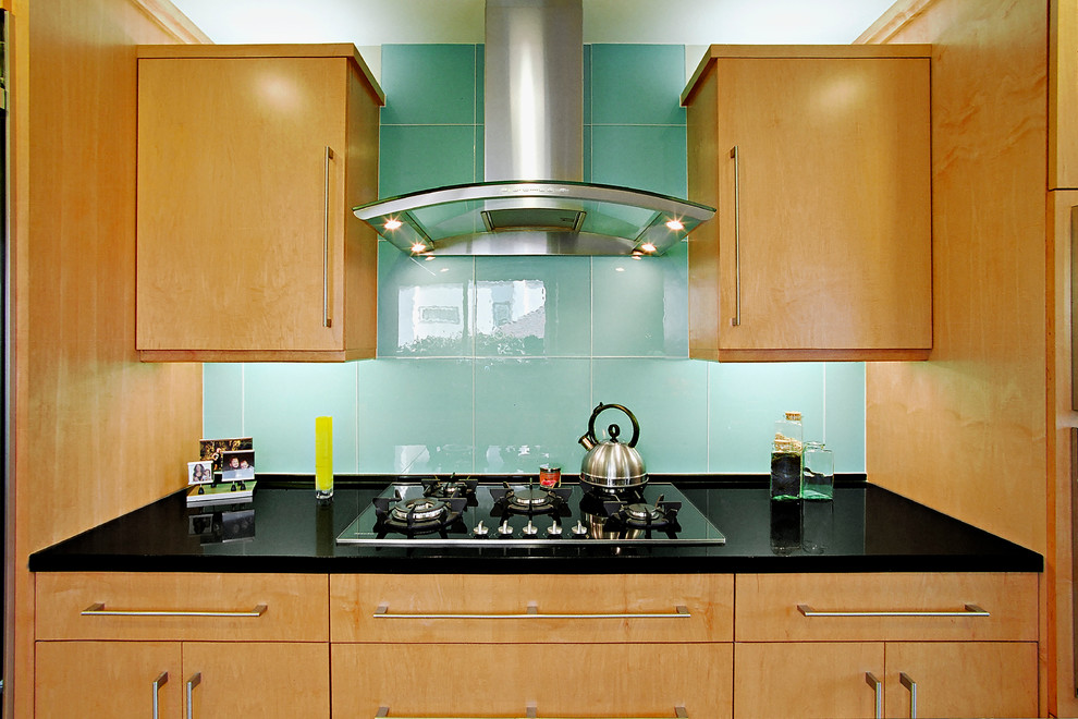 Kitchen - contemporary kitchen idea in Los Angeles with flat-panel cabinets, medium tone wood cabinets, blue backsplash and glass tile backsplash