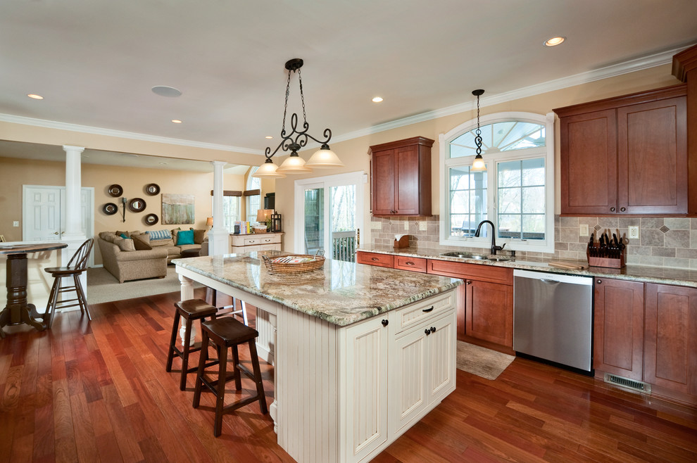 Eat-in kitchen - large transitional u-shaped medium tone wood floor eat-in kitchen idea in Philadelphia with an undermount sink, recessed-panel cabinets, medium tone wood cabinets, granite countertops, multicolored backsplash, subway tile backsplash, stainless steel appliances and an island