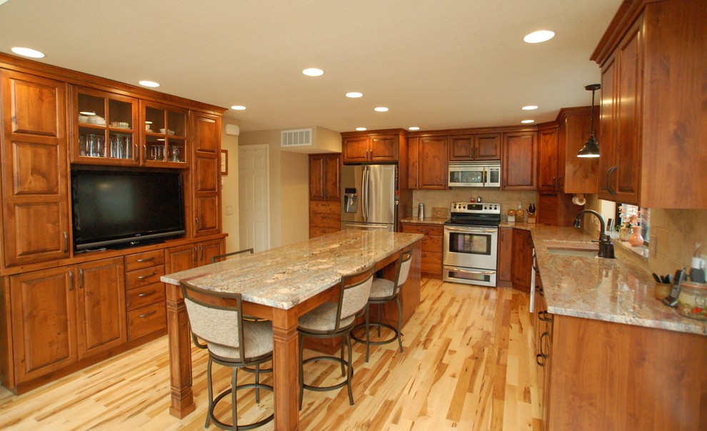 Large island with furniture-style legs and entertainment wall in ...