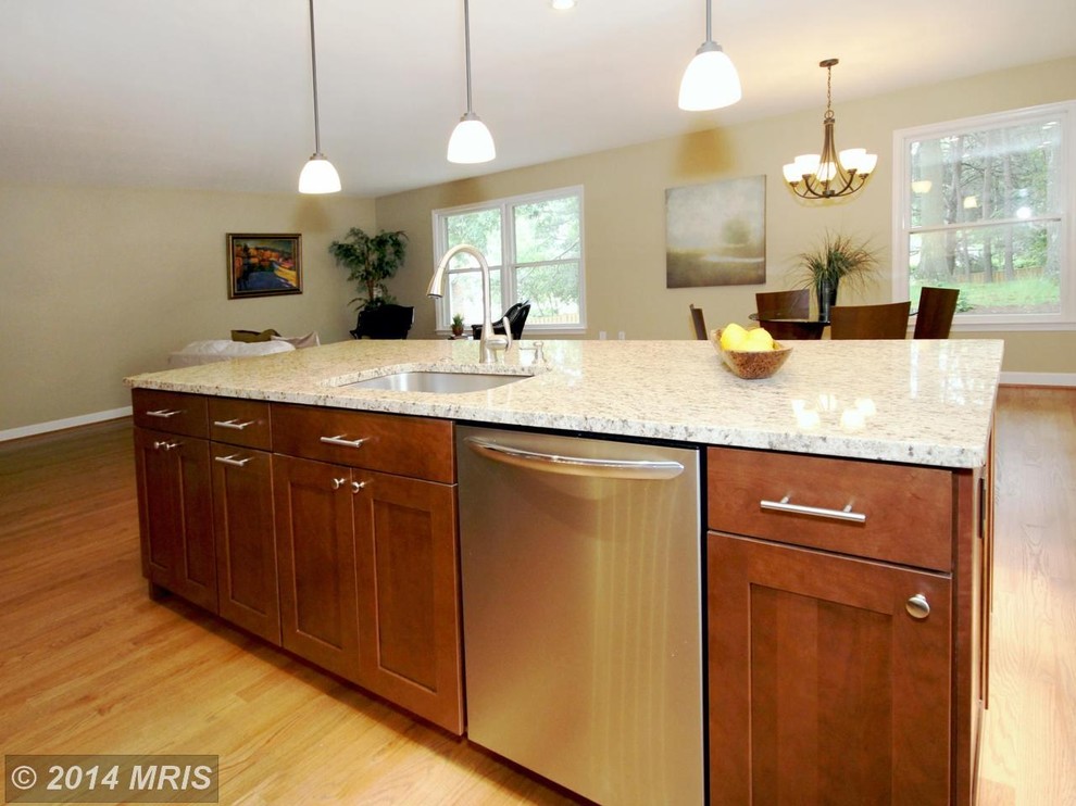 Mid-sized trendy single-wall light wood floor eat-in kitchen photo in DC Metro with a single-bowl sink, shaker cabinets, dark wood cabinets, granite countertops, brown backsplash, glass sheet backsplash, stainless steel appliances and an island