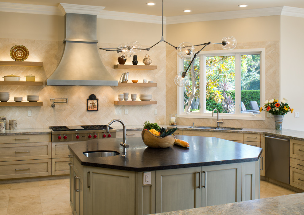 Inspiration for a large eclectic u-shaped limestone floor eat-in kitchen remodel in San Diego with an undermount sink, recessed-panel cabinets, distressed cabinets, granite countertops, beige backsplash, ceramic backsplash, stainless steel appliances and an island