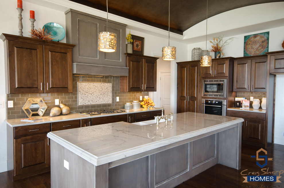 Inspiration for a mid-sized contemporary l-shaped dark wood floor open concept kitchen remodel in Wichita with a farmhouse sink, recessed-panel cabinets, dark wood cabinets, granite countertops, gray backsplash, subway tile backsplash, stainless steel appliances and an island