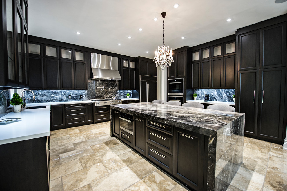 Photo of a large traditional u-shaped kitchen/diner in Toronto with a double-bowl sink, recessed-panel cabinets, grey cabinets, engineered stone countertops, grey splashback, stone slab splashback, stainless steel appliances, porcelain flooring and an island.